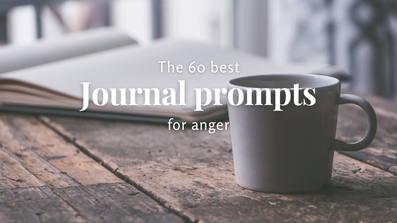 Cup of coffee and journal sitting open on a rustic wooden table. Text reads "The 60 Best Journal Prompts for Anger"